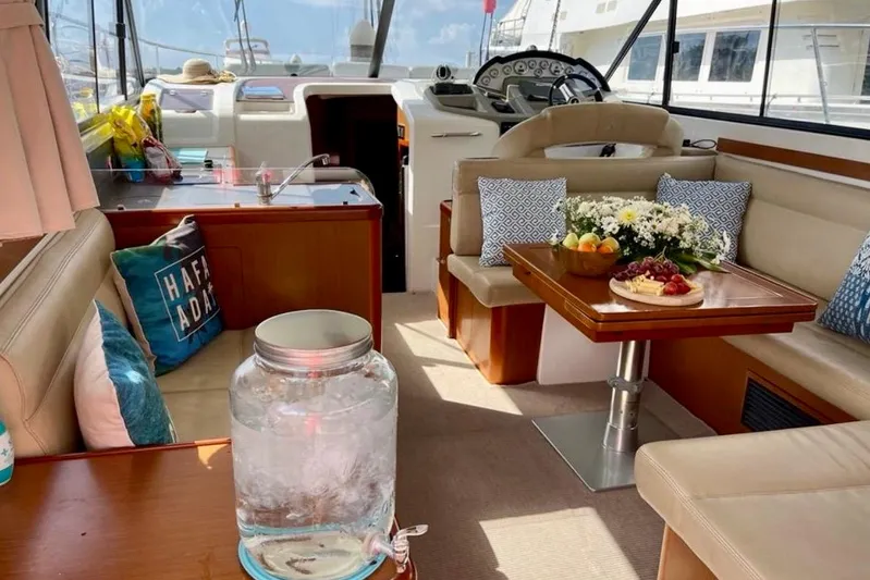  Yacht Photos Pics Interior of 2013 Beneteau Antares 42 yacht with cozy seating and dining area.