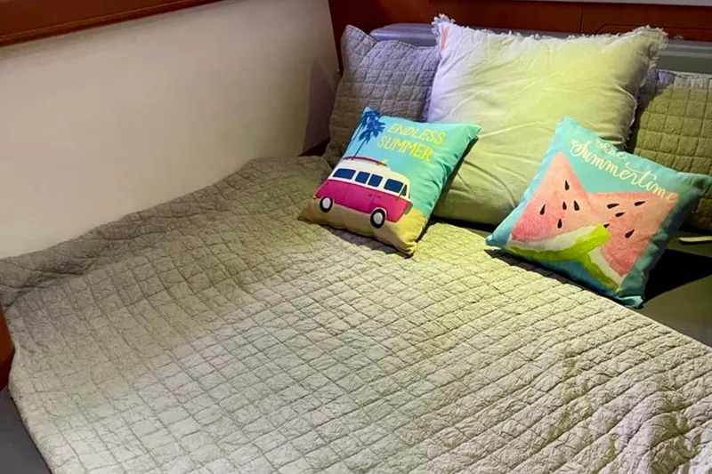  Yacht Photos Pics Cozy bedroom in 2013 Beneteau Antares 42 with colorful summer-themed pillows.