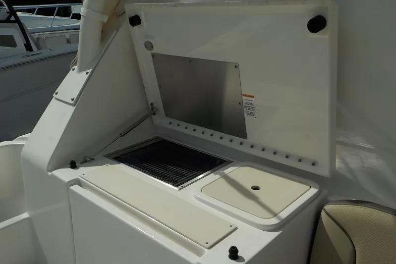  Yacht Photos Pics 2020 Pursuit OS 355 Offshore boat interior with built-in grill and storage compartment.