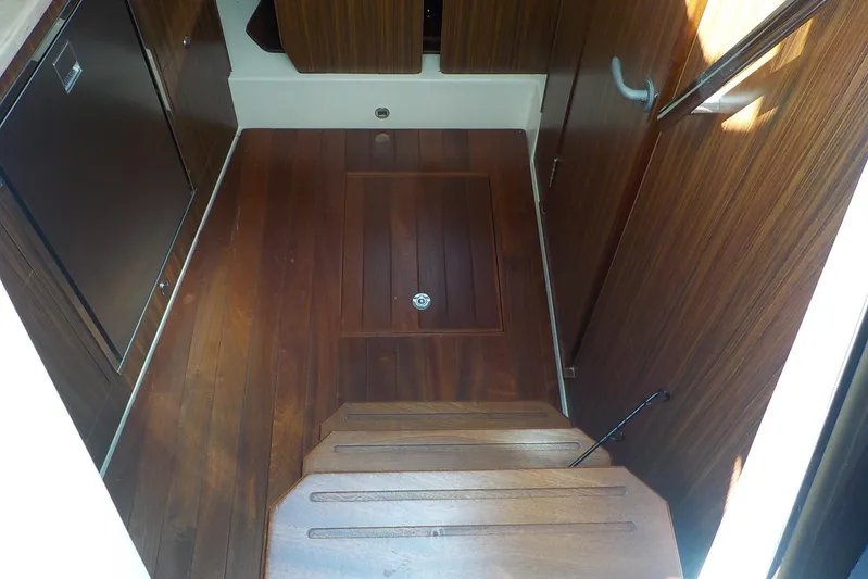  Yacht Photos Pics 2020 Pursuit OS 355 Offshore interior with wooden flooring and cabinetry.