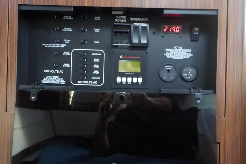  Yacht Photos Pics Control panel of a 2020 Pursuit OS 355 Offshore boat, featuring power switches and gauges.