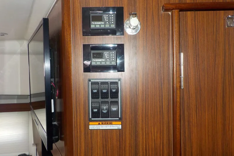  Yacht Photos Pics Control panel on 2020 Pursuit OS 355 Offshore boat with wood finish interior.