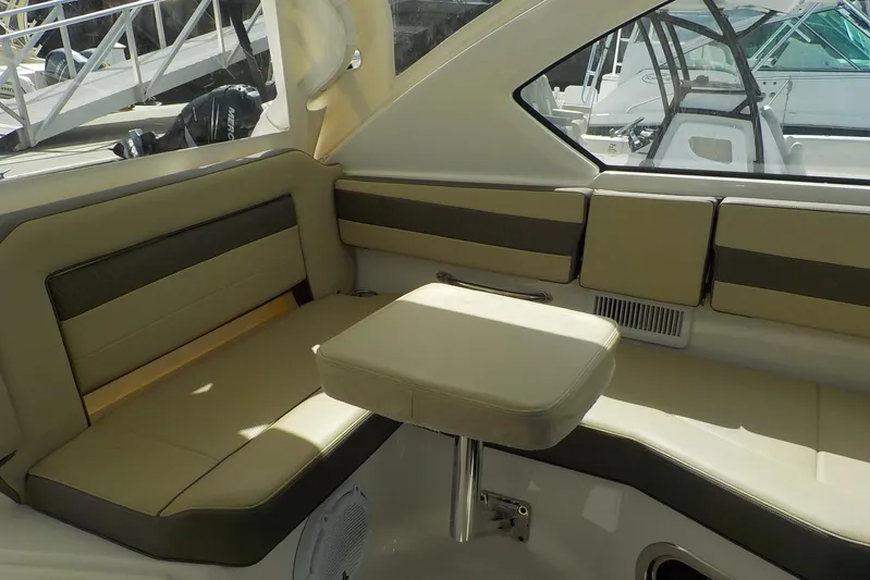  Yacht Photos Pics 2020 Pursuit OS 355 Offshore boat interior with beige seating and compact table.