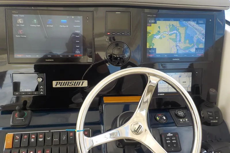  Yacht Photos Pics Control panel of a 2020 Pursuit OS 355 Offshore boat with Garmin navigation displays.