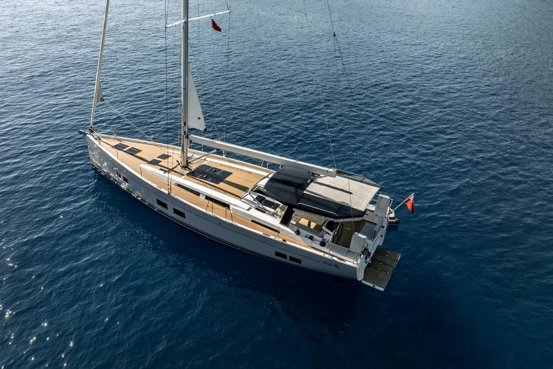 Hanse 588 Yacht Photos Pics 2024 Hanse 588 yacht sailing on calm blue waters, aerial view.