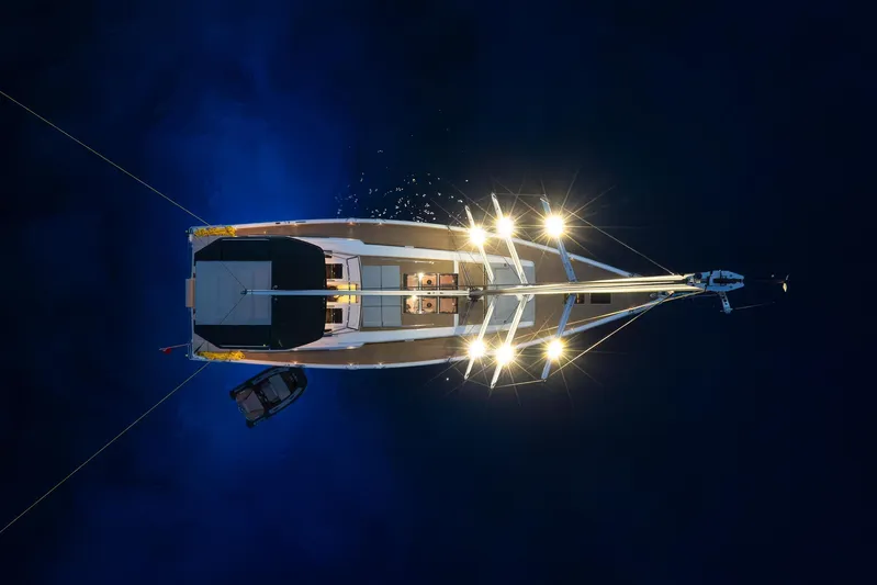 Hanse 588 Yacht Photos Pics Overhead view of illuminated 2024 Hanse 588 yacht on dark water.