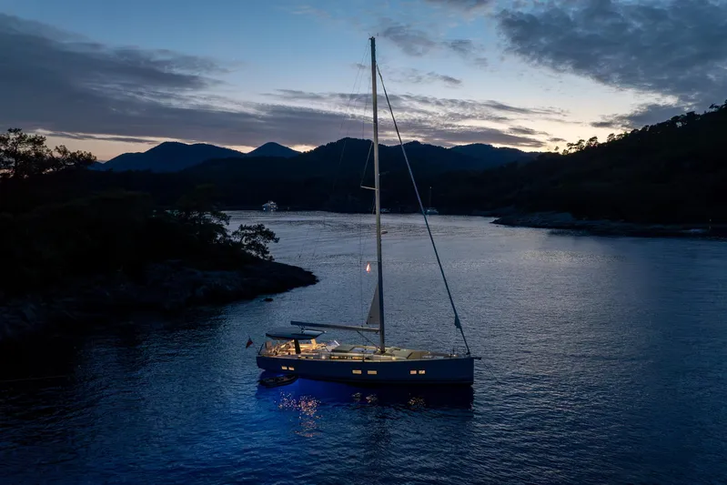 Hanse 588 Yacht Photos Pics Sailing yacht Hanse 588 (2024) illuminated at dusk on tranquil waters.