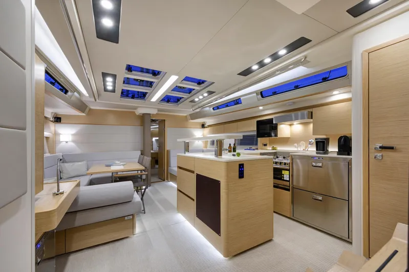 Hanse 588 Yacht Photos Pics Luxurious interior of 2024 Hanse 588 yacht with modern kitchen and seating area.