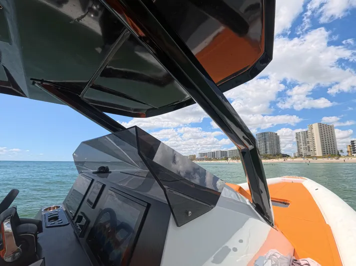 Novielli Yacht Photos Pics 2026 Novielli Veloche 349 boat on ocean near city skyline and beach.