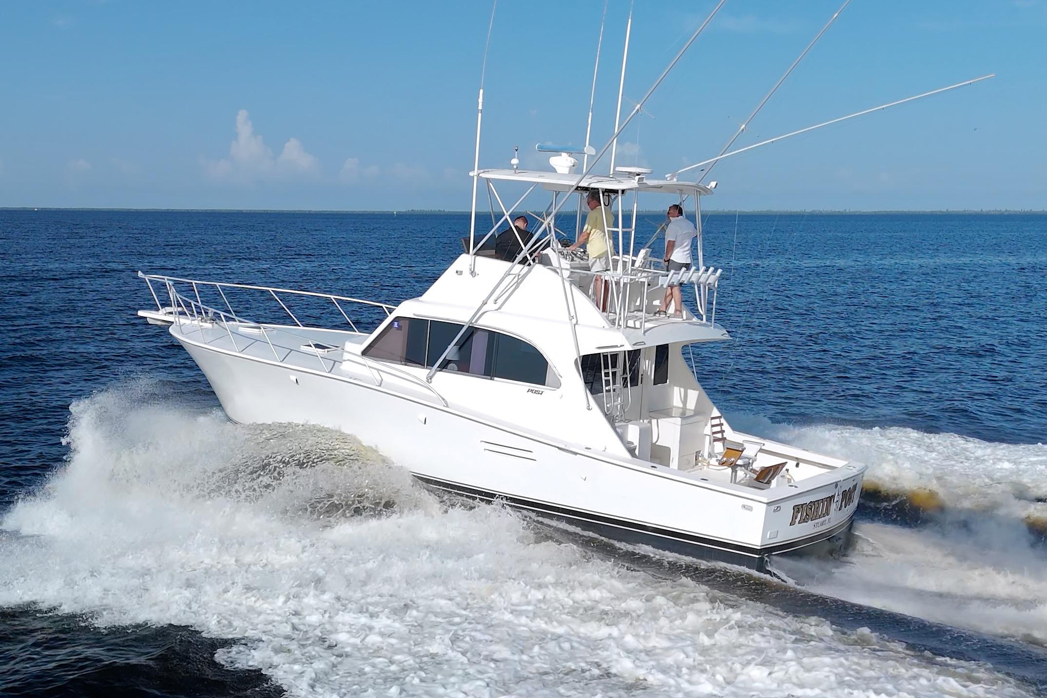 1990 Post 44 Sport Fisherman yacht cruising on open water.