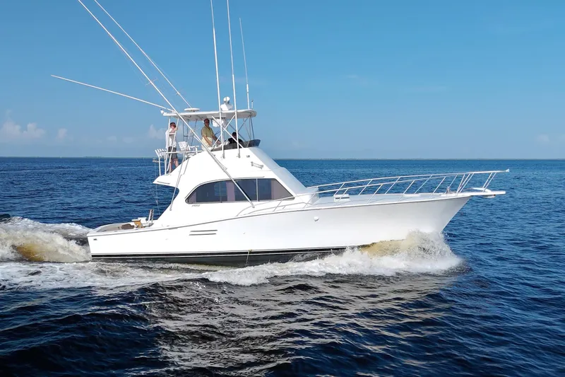 Fishin Post Yacht Photos Pics 1990 Post 44 Sport Fisherman yacht cruising on open water under clear blue sky.