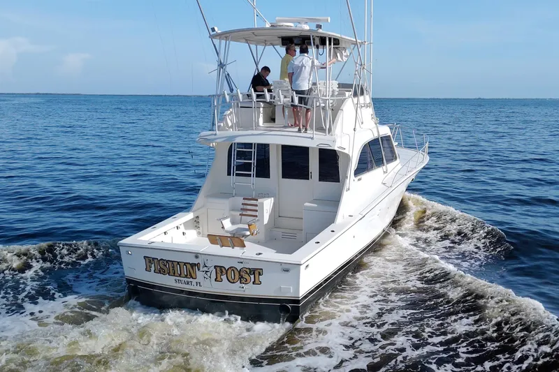 Fishin Post Yacht Photos Pics 1990 Post 44 Sport Fisherman boat cruising on open water, rear view.