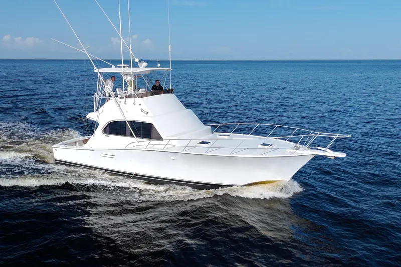 Fishin Post Yacht Photos Pics 1990 Post 44 Sport Fisherman yacht cruising on open water under clear blue skies.