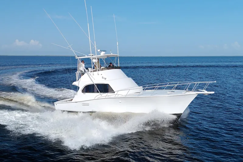 Fishin Post Yacht Photos Pics 1990 Post 44 Sport Fisherman cruising on open water under clear blue skies.