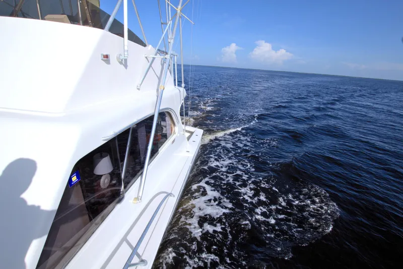 Fishin Post Yacht Photos Pics 1990 Post 44 Sport Fisherman yacht cruising on open sea under clear blue sky.