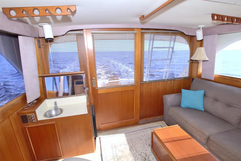 Fishin Post Yacht Photos Pics Interior of 1990 Post 44 Sport Fisherman yacht with sofa, sink, and ocean view.