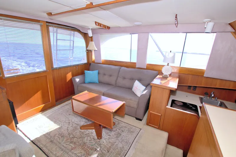 Fishin Post Yacht Photos Pics Interior of 1990 Post 44 Sport Fisherman yacht with sofa, table, and ocean view.
