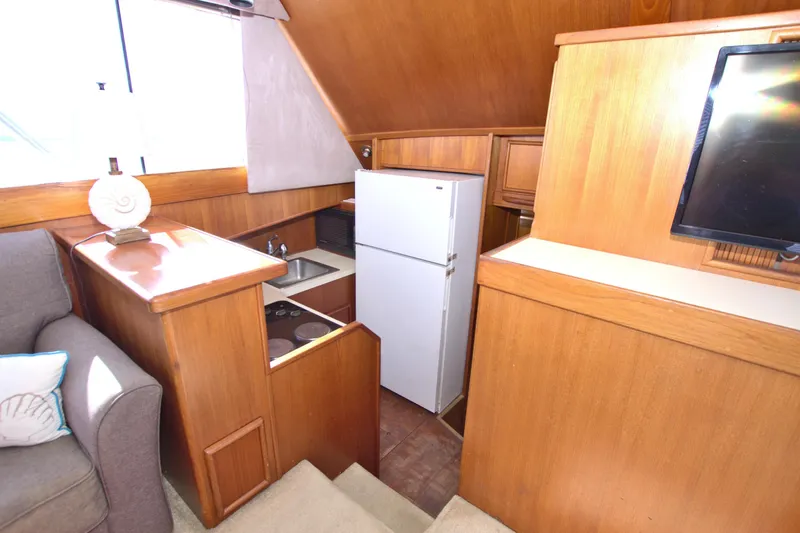 Fishin Post Yacht Photos Pics Interior of 1990 Post 44 Sport Fisherman yacht with kitchenette and seating area.