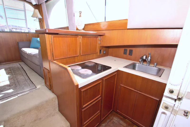 Fishin Post Yacht Photos Pics 1990 Post 44 Sport Fisherman yacht interior with compact kitchen and seating area.
