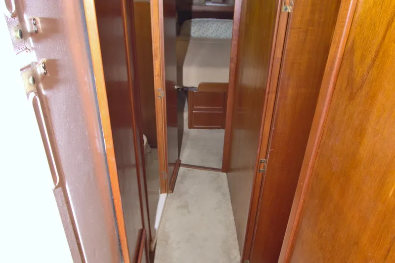 Fishin Post Yacht Photos Pics Narrow hallway inside 1990 Post 44 Sport Fisherman boat with wooden paneling.