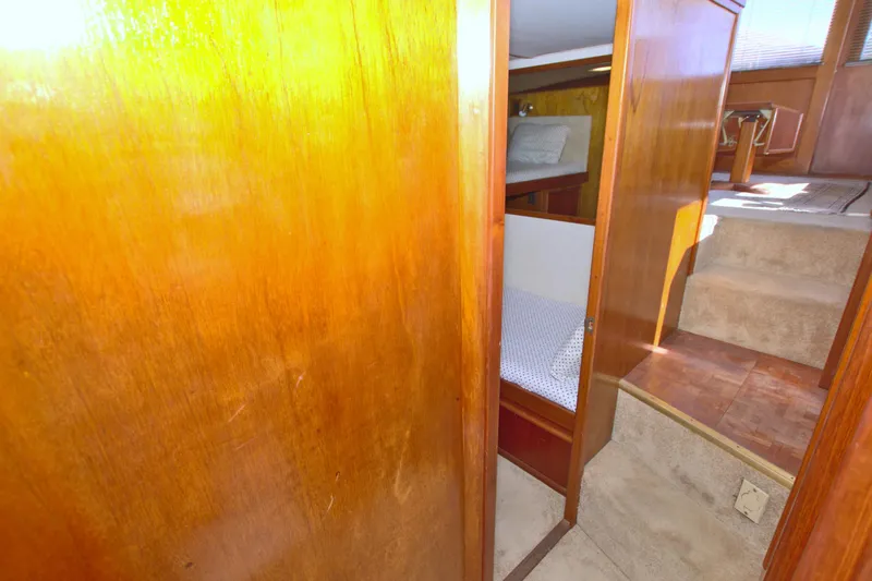 Fishin Post Yacht Photos Pics Interior of 1990 Post 44 Sport Fisherman yacht with wooden paneling and cozy sleeping area.