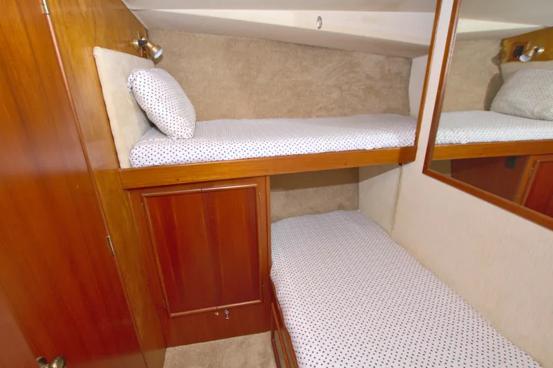 Fishin Post Yacht Photos Pics 1990 Post 44 Sport Fisherman cabin with wooden bunk beds and polka dot bedding.