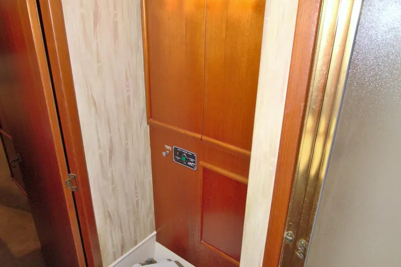 Fishin Post Yacht Photos Pics Interior of 1990 Post 44 Sport Fisherman, featuring wooden cabinetry and control panel.