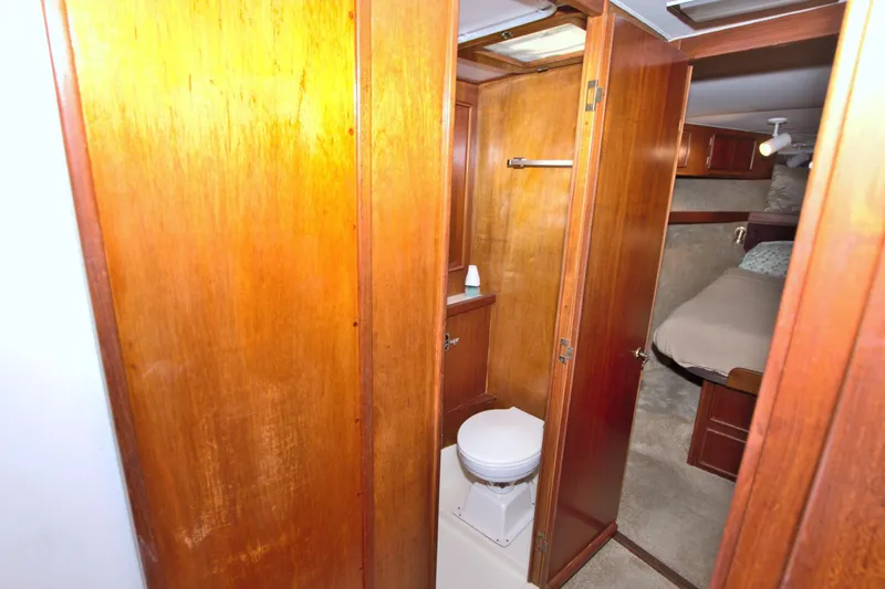 Fishin Post Yacht Photos Pics 1990 Post 44 Sport Fisherman yacht interior with wooden cabinetry and compact bathroom.