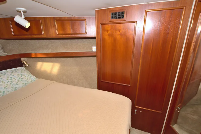 Fishin Post Yacht Photos Pics Cozy cabin interior of 1990 Post 44 Sport Fisherman with wood paneling and bed.