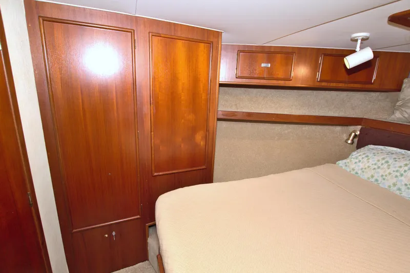 Fishin Post Yacht Photos Pics Cozy cabin interior of 1990 Post 44 Sport Fisherman with wooden cabinetry and bed.