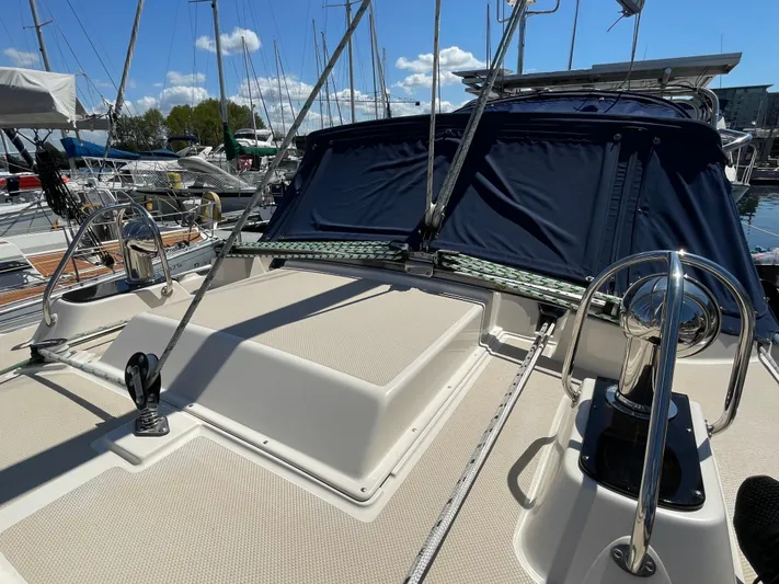  Yacht Photos Pics 2002 Island Packet 380 sailboat deck with blue canvas cover in marina setting.