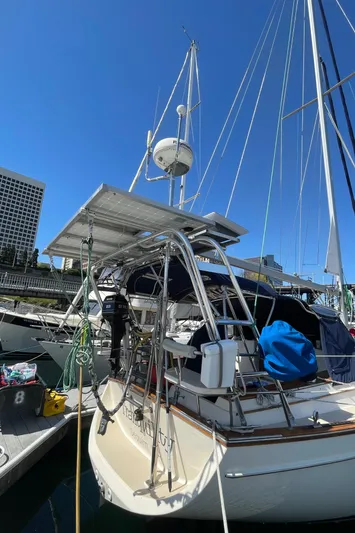  Yacht Photos Pics 2002 Island Packet 380 sailboat docked at marina under clear blue sky.