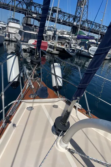  Yacht Photos Pics 2002 Island Packet 380 sailboat docked in marina, with bridge in background.
