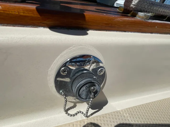  Yacht Photos Pics Fuel cap on a 2002 Island Packet 380 sailboat deck, with chain and textured surface.