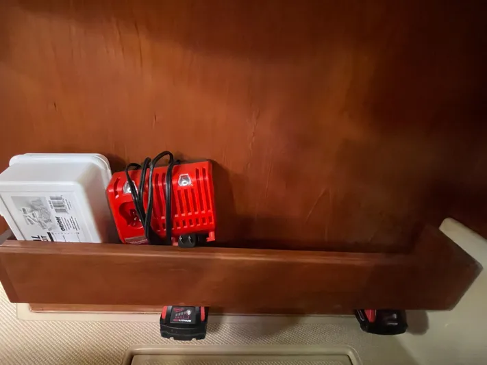  Yacht Photos Pics Wooden shelf with tools and charger on Island Packet 380, 2002 model.