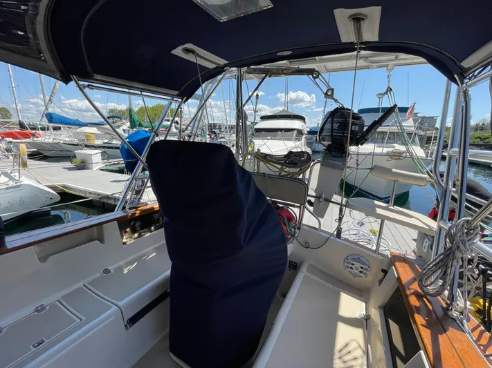  Yacht Photos Pics 2002 Island Packet 380 sailboat cockpit with covered helm, docked at marina.