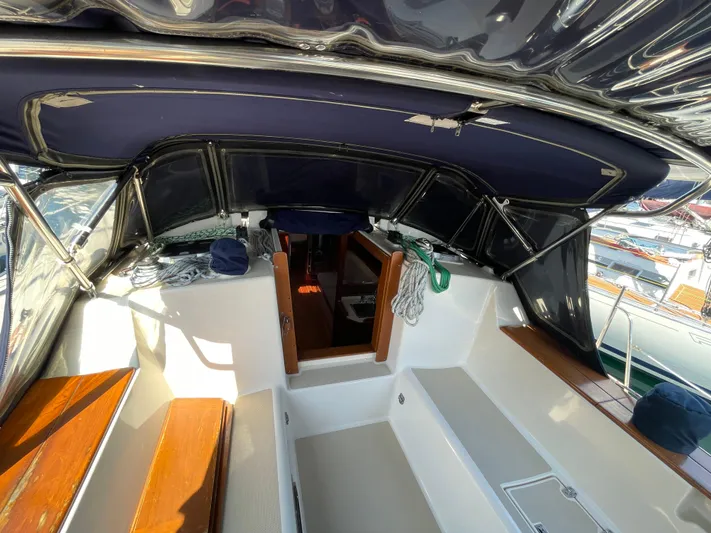  Yacht Photos Pics 2002 Island Packet 380 sailboat cockpit with seating, canopy, and entryway to cabin.