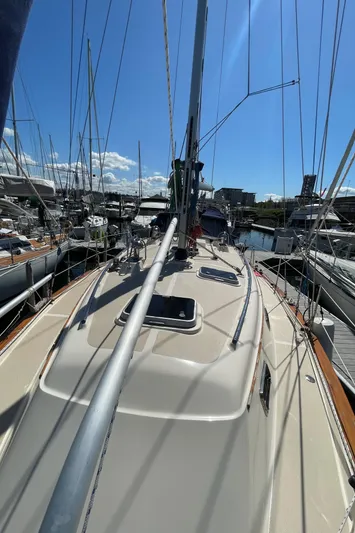  Yacht Photos Pics 2002 Island Packet 380 sailboat deck view in marina under clear blue sky.