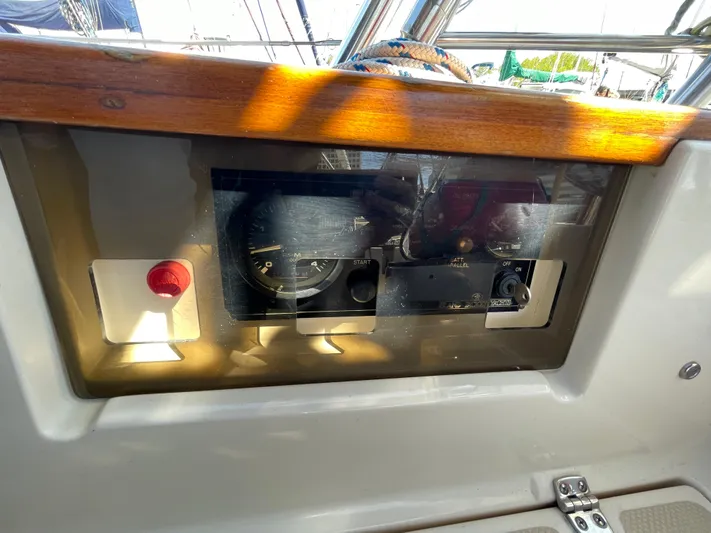  Yacht Photos Pics Control panel of a 2002 Island Packet 380 sailboat with gauges and a red button.