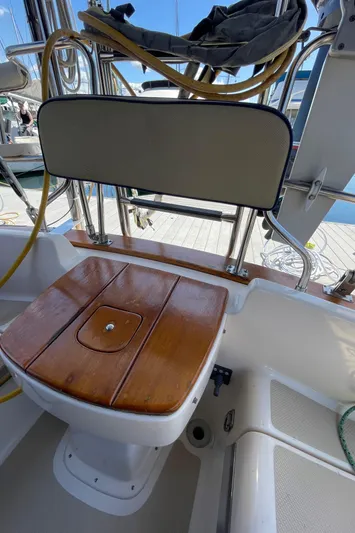  Yacht Photos Pics 2002 Island Packet 380 sailboat cockpit with wooden seat and backrest.