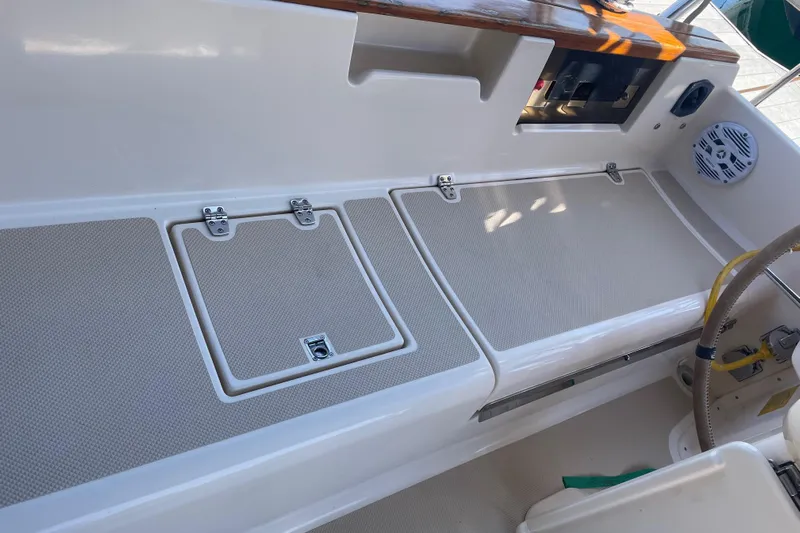  Yacht Photos Pics Island Packet 380 cockpit area, 2002 model, featuring storage compartments and steering wheel.