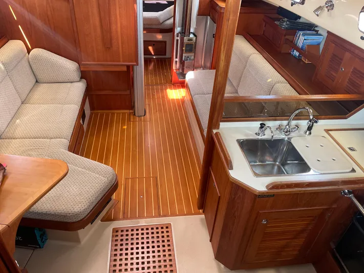  Yacht Photos Pics Interior of 2002 Island Packet 380 sailboat with wood finish and cozy seating area.