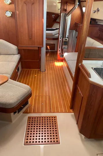  Yacht Photos Pics Interior of 2002 Island Packet 380 sailboat with wood flooring and cozy seating.