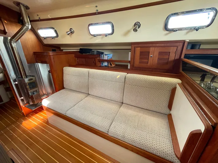  Yacht Photos Pics Interior of 2002 Island Packet 380 sailboat with cozy seating and wooden accents.