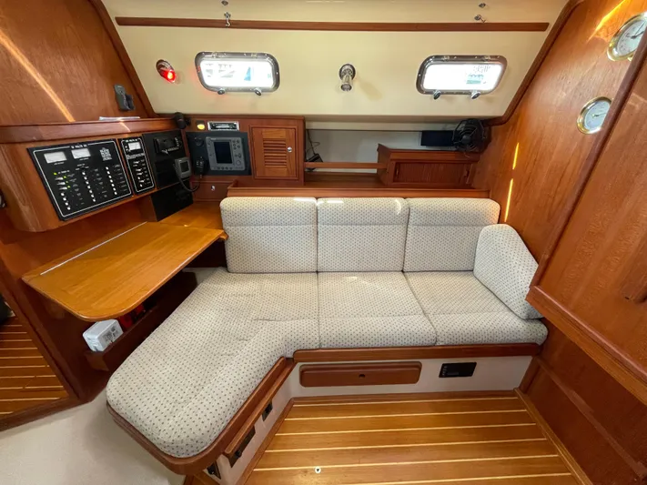  Yacht Photos Pics Interior of 2002 Island Packet 380 sailboat with cozy seating and navigation station.