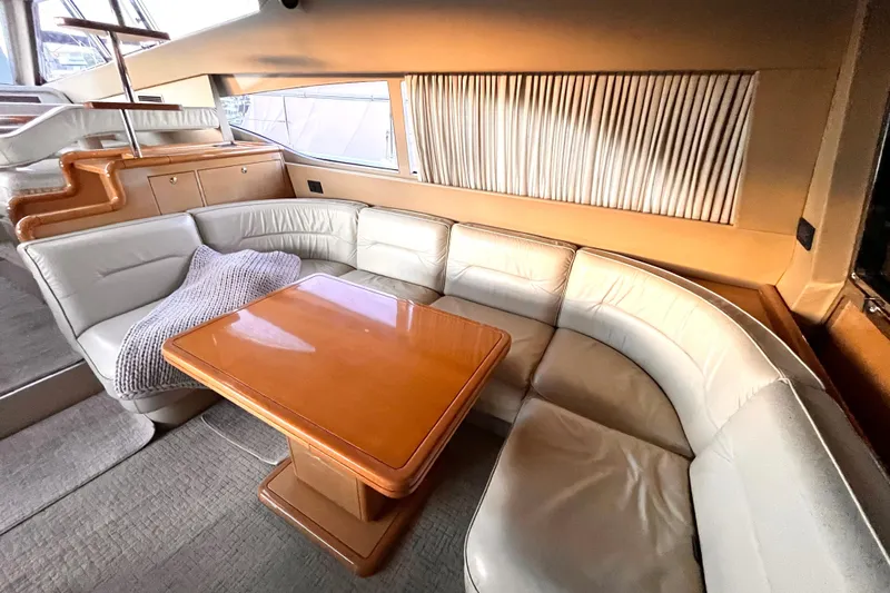 Resilient Sea Yacht Photos Pics Luxurious interior of 2004 Ferretti Yachts 530 with plush seating and wooden table.