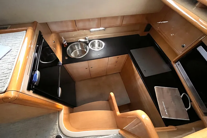 Resilient Sea Yacht Photos Pics 2004 Ferretti Yachts 530 kitchen with modern appliances and sleek wooden cabinetry.