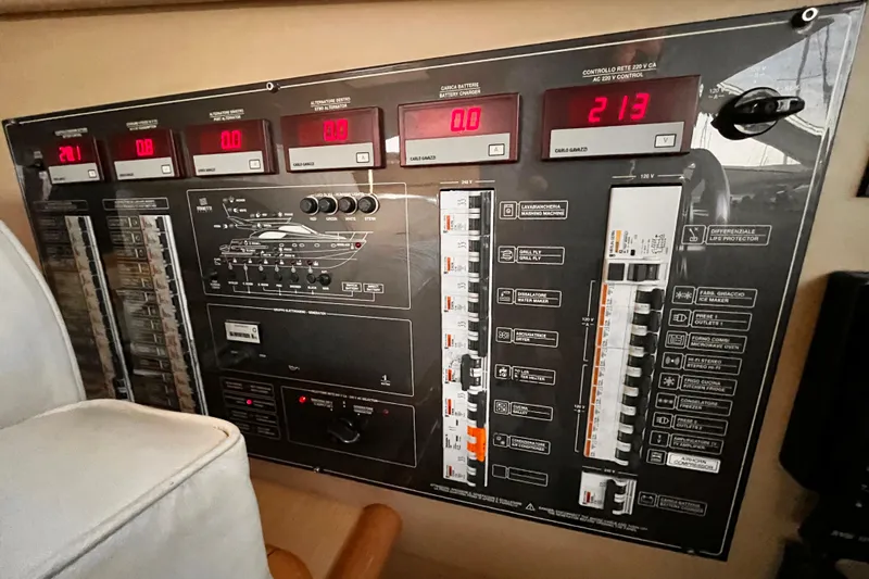 Resilient Sea Yacht Photos Pics Control panel of a 2004 Ferretti Yachts 530, featuring various switches and digital displays.