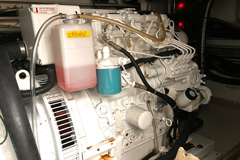 Resilient Sea Yacht Photos Pics Engine compartment of a 2004 Ferretti Yachts 530, showcasing mechanical components and fluid reservoirs.