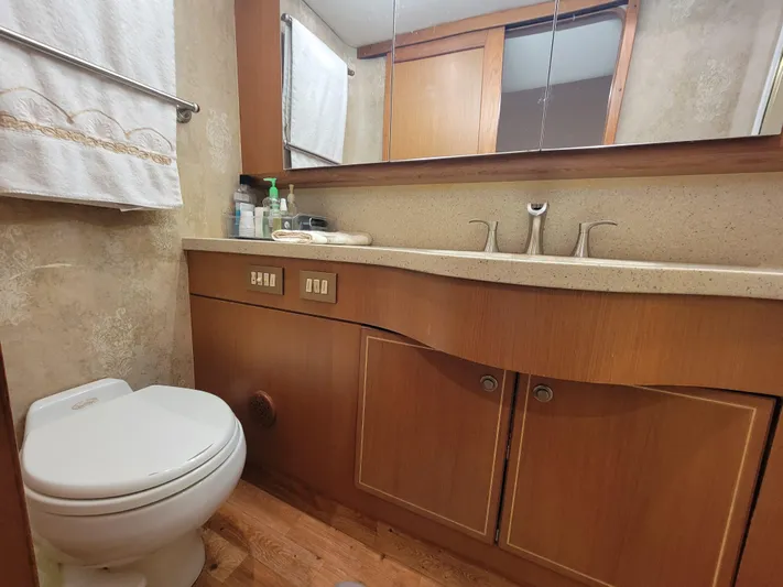  Yacht Photos Pics Luxurious bathroom in 2005 Ocean Yachts 57 Super Sport, featuring wood cabinetry and modern fixtures.